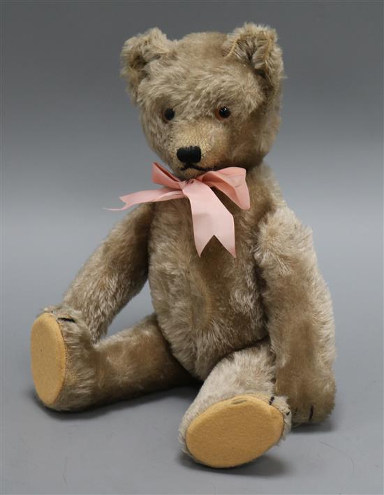 A 1950s Schuco Yes/No teddy bear, Ria, with beige mohair, brown and black glass eyes, pronounced clipped
